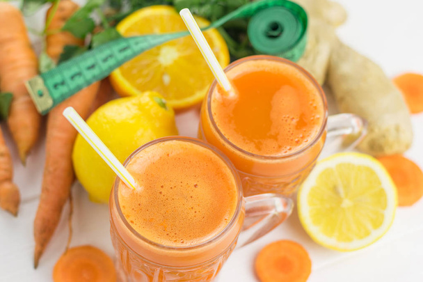 Carrot smoothie with grapefruit and parsley on a wooden table top view. - Foto, Imagen