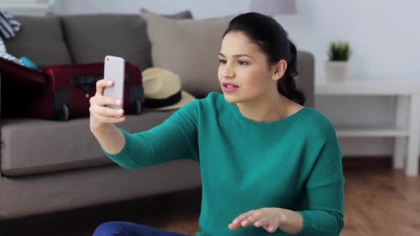 woman with smartphone and travel stuff at home - Filmmaterial, Video