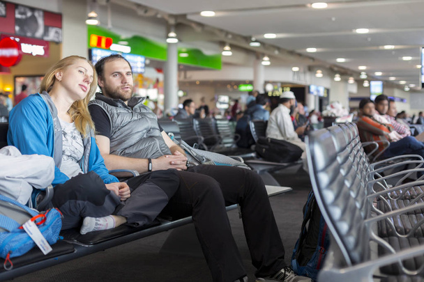 Man and woman sitting at airport - 写真・画像