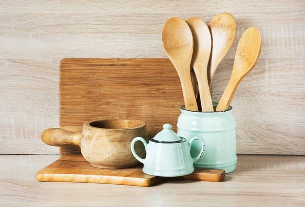 Turquoise and wooden vintage crockery, tableware, dishware utensils and stuff on wooden table-top. Kitchen still life as background for design. Image with copy space. - Photo, Image