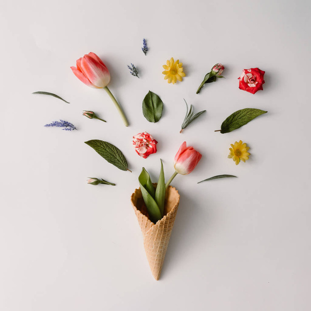 Ice cream cone with colorful flowers  - 写真・画像