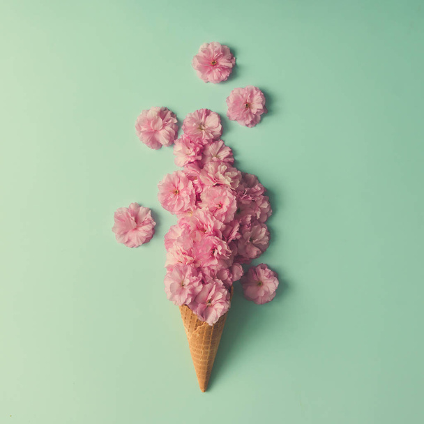 Ice cream cone with pink flowers  - Photo, Image