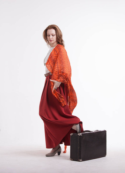 Woman standing on white background with suitcase. - Valokuva, kuva