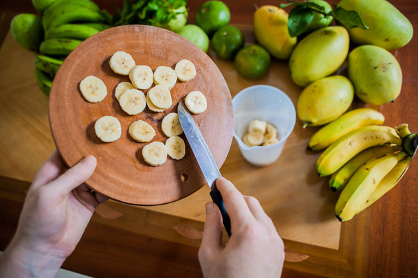 Sliced banana on cutting board  - Фото, зображення