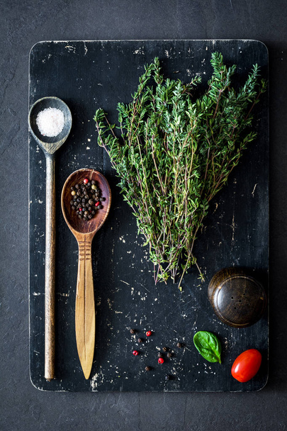 Thyme and spices on cutting board. Ingredients for healthy cooking - 写真・画像