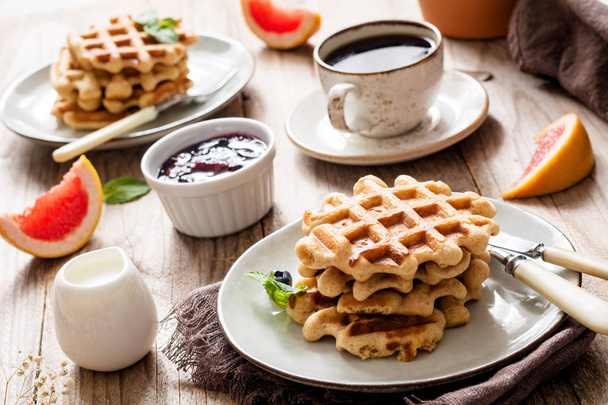 Breakfast table with waffles, coffee, jam and fruits - Fotoğraf, Görsel