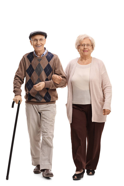 Elderly man and woman walking towards the camera - Фото, изображение