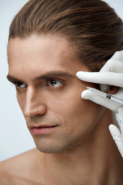 Handsome Male Receiving Cosmetic Injection, Facial Treatment - Valokuva, kuva
