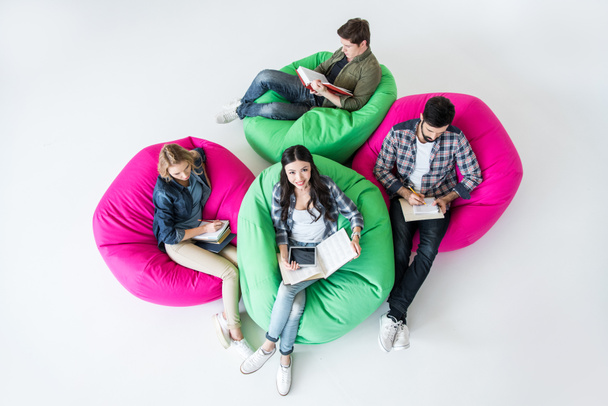 students sitting on beanbag chairs - Фото, зображення