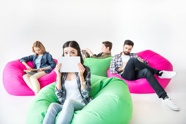 students sitting on beanbag chairs - Foto, afbeelding