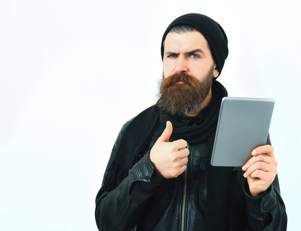 Bearded brutal caucasian hipster holding tablet - Photo, Image