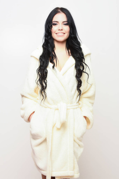 sexy smiling girl posing in beige velour bathrobe - Zdjęcie, obraz