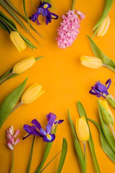 Colorful flowers on the yellow background vertical - Foto, afbeelding