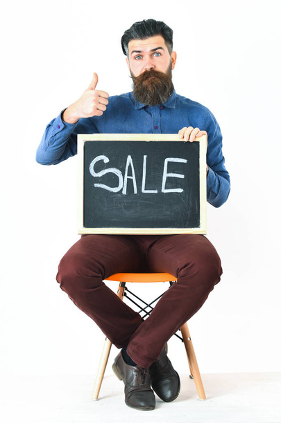 Bearded man, brutal caucasian hipster with moustache holding sale inscription - Фото, зображення
