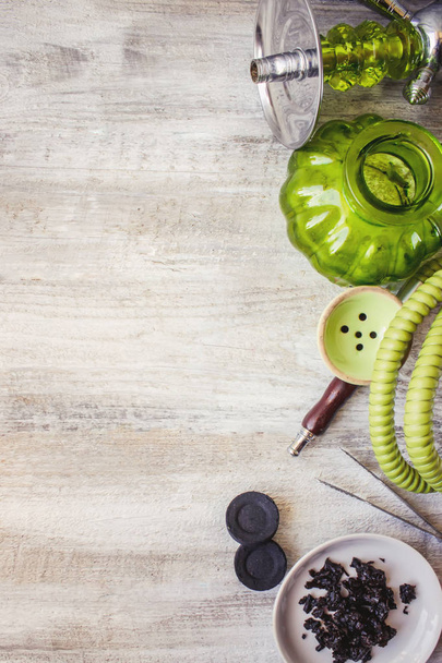 Hookah on a wooden background. Tobacco fruit. Selective focus.  - 写真・画像