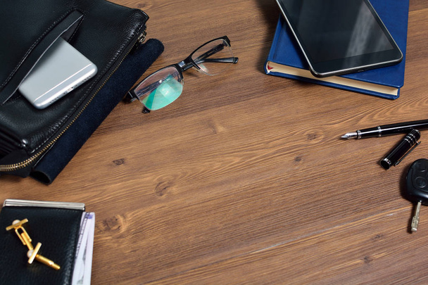 Business accessories on desktop: bag, watch, pen, perfume, cufflink and phone. Success in business. - Foto, Bild