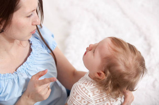 Woman berates crying baby at home - Фото, изображение
