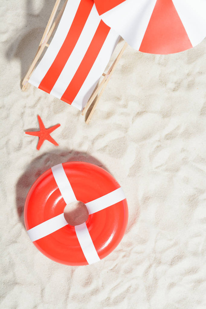 Deckchair and swimming ring on the beach: top view - Photo, Image