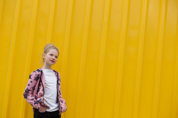 Portrait of a beautiful girl with red lips on a yellow backgroun - Zdjęcie, obraz