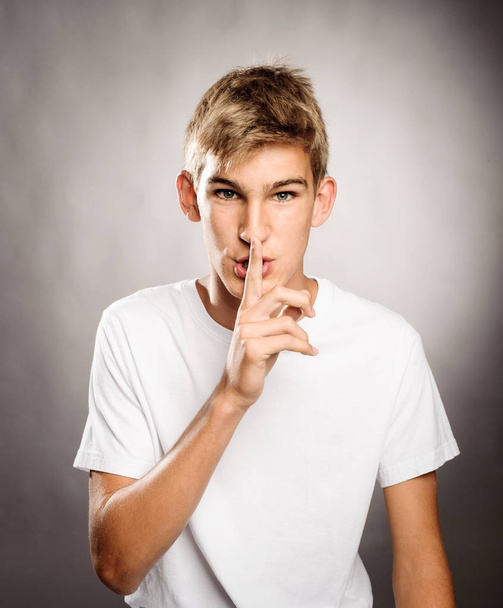 jonge man met stilte gebaar - Foto, afbeelding