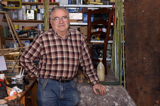 portrait of a retired carpenter in his workshop - Foto, imagen