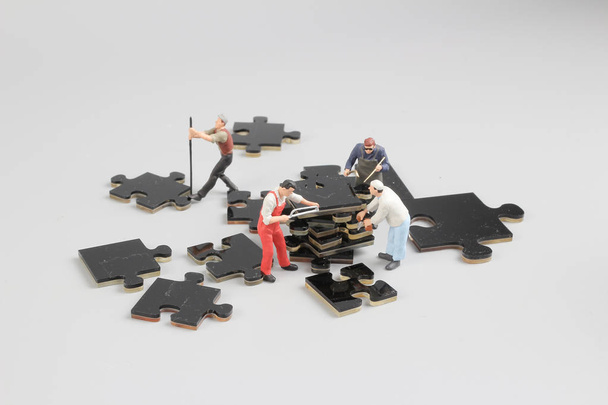 mini tiny builders at puzzle construction site - Photo, Image