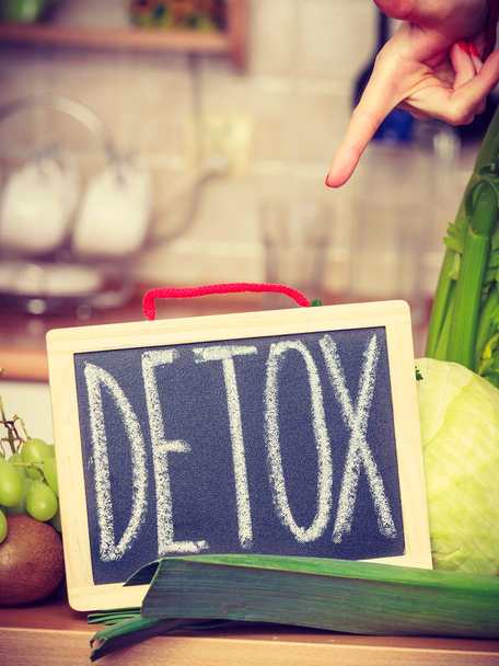 Woman having green diet vegetables, detox sign - 写真・画像