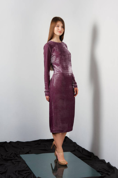 Attractive fashion model in long silk velvet dress posing - Zdjęcie, obraz