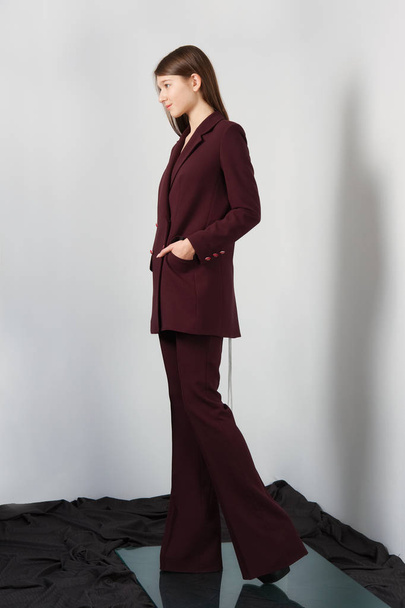Attractive fashion model in pantsuit with lacing on back - Foto, Bild