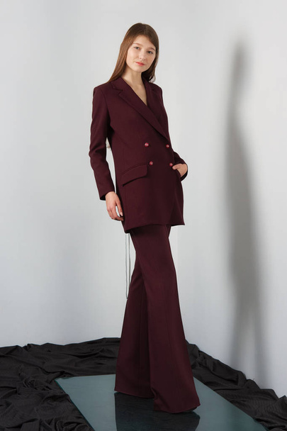 Attractive fashion model in pantsuit with lacing on back - Foto, immagini
