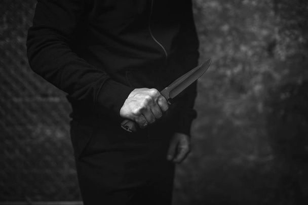 Raining hateful law breaker holding a dagger - Valokuva, kuva