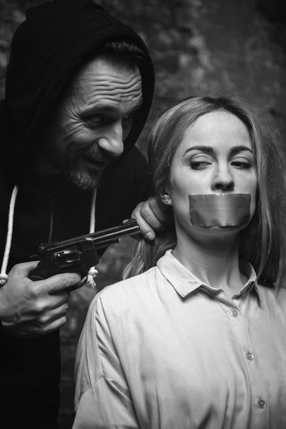 Crazy evil abductor demanding victims obedience - Valokuva, kuva