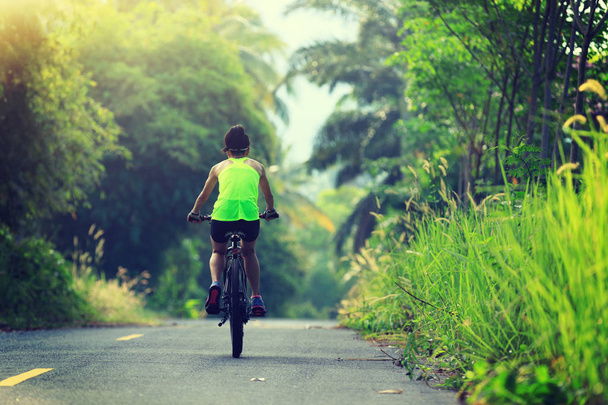 Young  woman riding bicycle - Foto, Bild