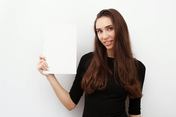 Woman student hold white blank card isolated on white background. Girl model poses. - Foto, imagen