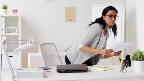businesswoman with laptop and papers at office - Filmagem, Vídeo