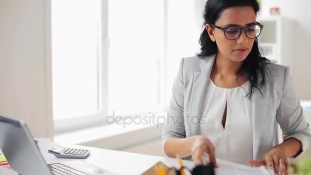 businesswoman with laptop and papers at office - Záběry, video