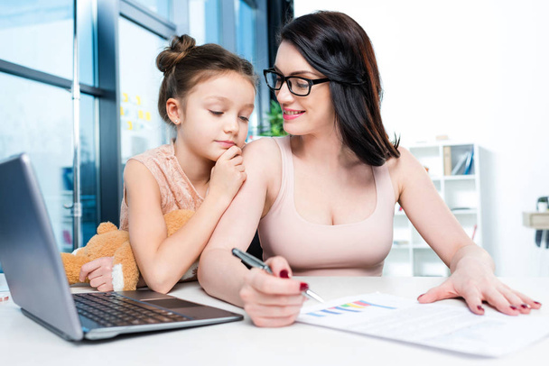 businesswoman with daughter in office - Photo, image