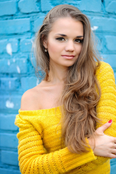 Portrait of a beautiful girl in a knitted sweater - Zdjęcie, obraz