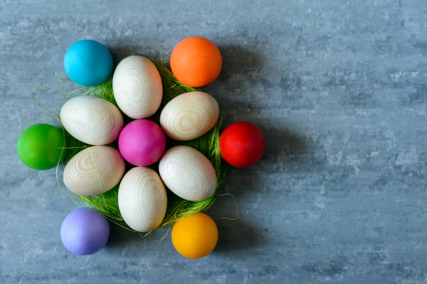 Top view of Easter eggs in a basket on concrete background - Fotó, kép