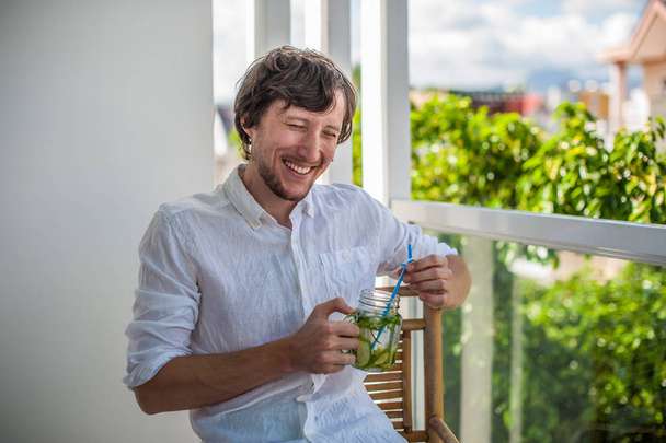 Man drinking a mojito on the terrace. - Φωτογραφία, εικόνα