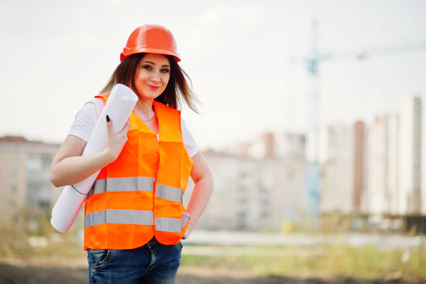 Engineer builder woman in uniform waistcoat and orange protectiv - Foto, imagen