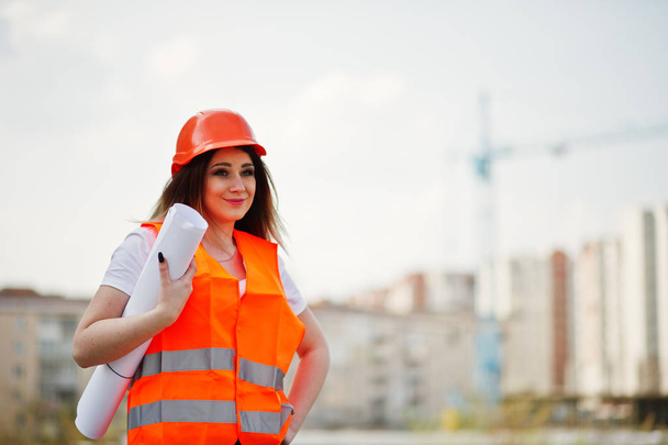 Engineer builder woman in uniform waistcoat and orange protectiv - Foto, imagen