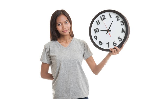 Young Asian woman with a clock. - Foto, Bild