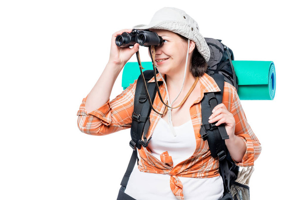 female tourist looking in binoculars on a white background - Фото, изображение