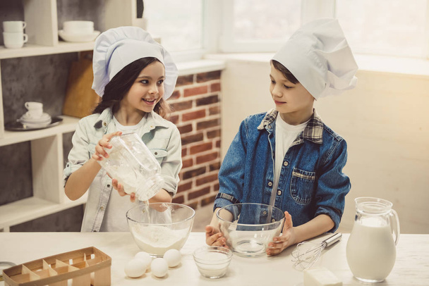 Children baking in kitchen - Фото, зображення
