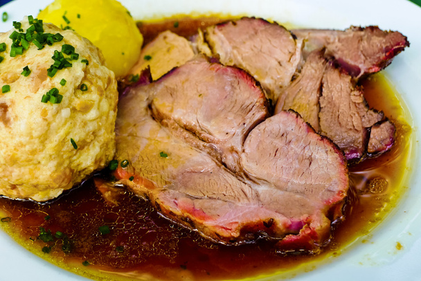 Roast pork on a plate at the inn - Foto, afbeelding