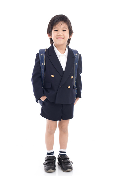 Criança asiática em uniforme escolar com saco de escola azul
  - Foto, Imagem