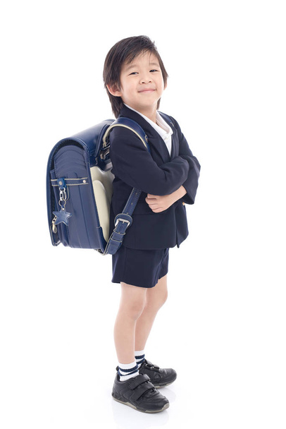 Asian child in school uniform with blue school bag  - Φωτογραφία, εικόνα