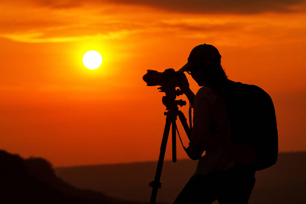 silhouette of asian women photography take a photo with mountain - Photo, Image