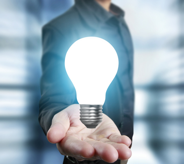  business person holding light bulb  - Photo, Image